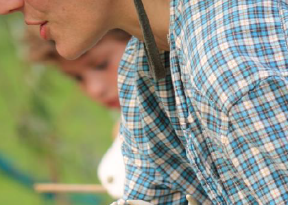 closeup of the torso of a person wearing a plaid shirt