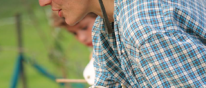 closeup of the torso of a person wearing a plaid shirt