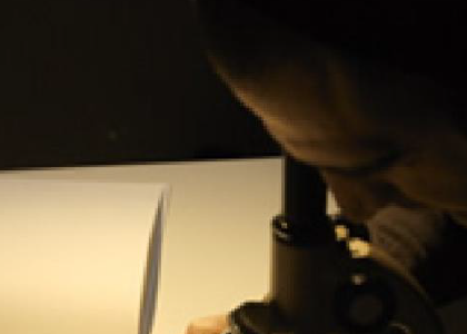 a person looking into a microscope