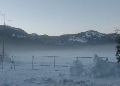 evening fog on a snowy lake