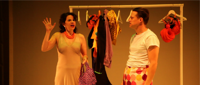 two actors in a state of undress in front of a wardrobe rack