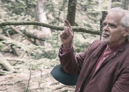 Actor David King in the forest pointing. Photo by Sophia Dagher.