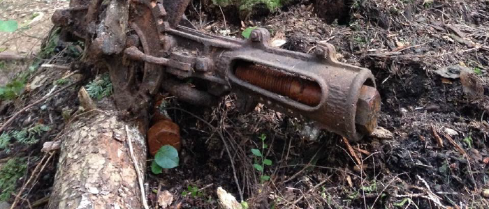 closeup of a old abandoned rusted bit of forestry equipment